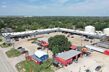 Katy apartment for rent - A large industrial area with a variety of buildings and vehicles.