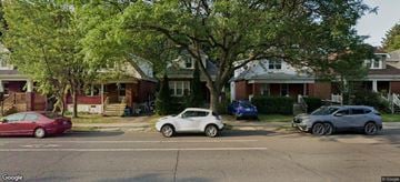 Hamilton apartment for rent - A street view with cars and houses.