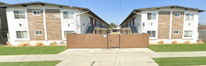 Gardena apartment for rent - A gated community with two buildings in the background.