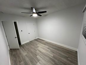 Gardena apartment for rent - A room with a ceiling fan and wood flooring.