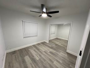 Gardena apartment for rent - A room with a ceiling fan and a mirror on the wall.