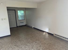 Matewan apartment for rent - A room with a door and a window with a white wall and a carpet.