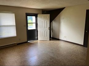 Matewan apartment for rent - A room with a black door, a white door, and a window with blinds.