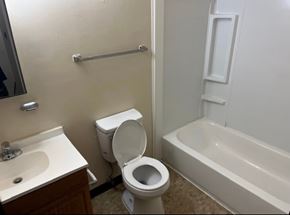 Matewan apartment for rent - A white toilet sits next to a sink in a bathroom.