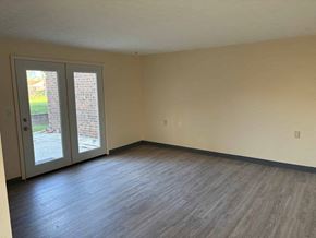 Wapakoneta apartment for rent - A room with a sliding glass door and wood flooring.