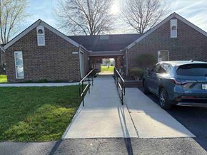 Wapakoneta apartment for rent - A brick building with a car parked in front.