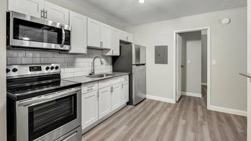 Las Vegas apartment for rent - A kitchen with white cabinets and stainless steel appliances.