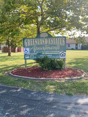 Coldwater apartment for rent - A sign for Greenland Estates Apartments is in front of a tree.