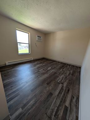Coldwater apartment for rent - A room with wooden flooring and a window.