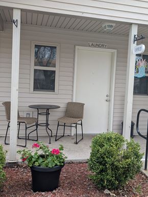 Coldwater apartment for rent - A small white building with a laundry sign on the door.