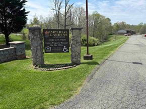 Spencer apartment for rent - A sign for Imperial Gardens apartments stands in a grassy area.