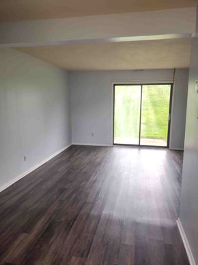 Byesville apartment for rent - A room with wooden flooring and a sliding glass door.