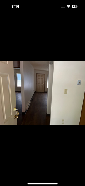 Logan apartment for rent - A long hallway with a door at the end.
