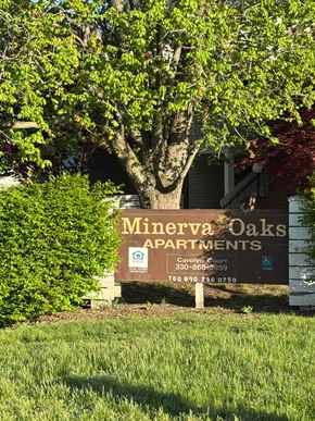 Minerva apartment for rent - A sign for Minerva Oaks Apartments stands in front of a tree.