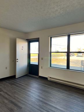 Malvern apartment for rent - A room with a door and a window overlooking a parking lot.