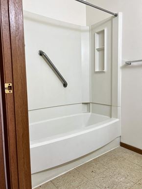 Malvern apartment for rent - A white bathroom with a walk-in shower and a door.