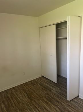 Bluffton apartment for rent - A room with a white door and a brown floor.