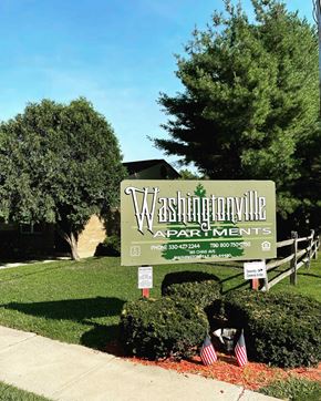Washingtonville apartment for rent - A sign for Washingtonville Apartments is displayed in front of a building.