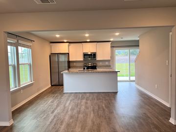 Gulfport house for rent - A kitchen with a white countertop and a refrigerator.
