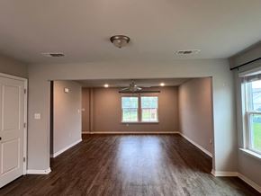 Gulfport house for rent - A room with wooden flooring and a window with blinds.