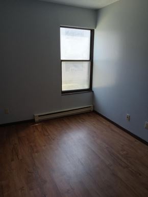 Weston apartment for rent - A room with a window and a wooden floor.