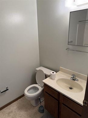 Loudonville apartment for rent - A white toilet with a roll of toilet paper on top of it is in a bathroom.