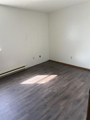 Loudonville apartment for rent - A room with a wooden floor and white walls.