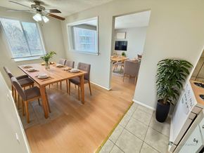 Denver apartment for rent - A dining room with a table set for six with a plant on the side.