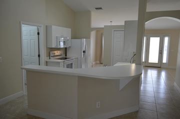 Cape Coral house for rent - A kitchen with a counter and cabinets.