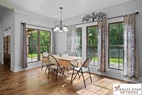 Hattiesburg house for rent - A dining room with a table set for four and a Realty Star Network logo.