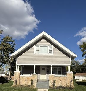 Lima house for rent - A house with a grey siding and a white door is shown.