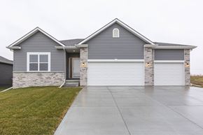 Gretna apartment for rent - A grey house with a white garage door.