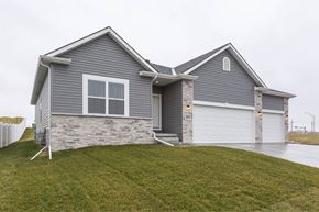 Gretna apartment for rent - A house with a grey siding and a white garage door.