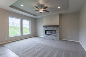 Gretna apartment for rent - A spacious room with a fireplace and a ceiling fan.
