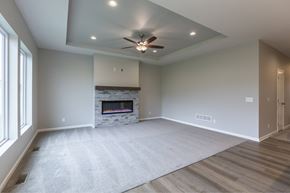 Gretna apartment for rent - A spacious living room with a fireplace and a ceiling fan.