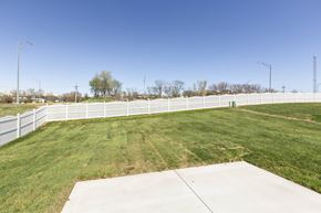Gretna apartment for rent - A large, open grassy area with a white fence and a concrete pathway.