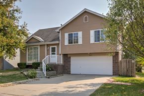 Omaha apartment for rent - A house with a brown exterior and a white garage door.