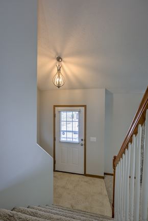 Omaha apartment for rent - A staircase with a light hanging above it.
