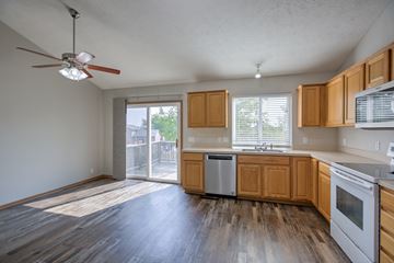 Omaha apartment for rent - A kitchen with wooden cabinets and a fan on the ceiling.
