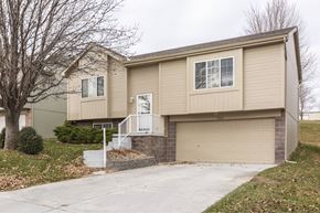 Omaha apartment for rent - A beige house with a white door and windows.