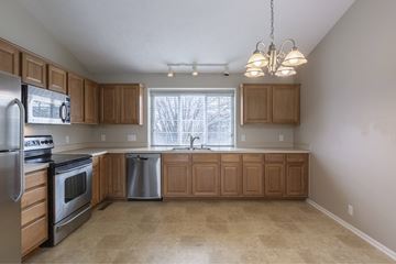 Omaha apartment for rent - A kitchen with wooden cabinets and stainless steel appliances.