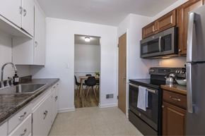 Omaha apartment for rent - A kitchen with a black oven and a black microwave.