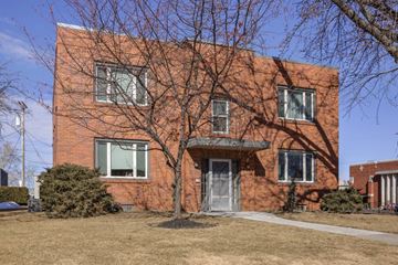 Omaha apartment for rent - A red brick building with a tree in front.