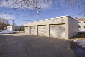 Omaha apartment for rent - A building with a grey roof and grey garage doors.