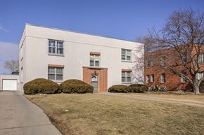 Omaha apartment for rent - A white building with a red door and windows.