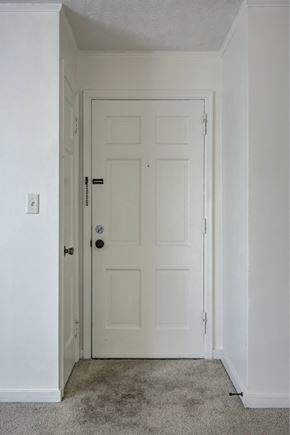 Omaha apartment for rent - A white door with a black handle and lock.
