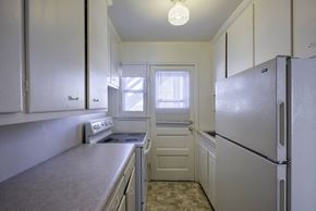 Omaha apartment for rent - A kitchen with white cabinets and a refrigerator.