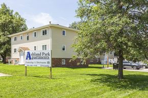 Ashland apartment for rent - A sign for Ashland Park Apartments is in front of a two-story building.