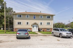 Ashland apartment for rent - A two-story house with a car parked in front.