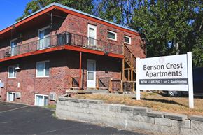 Omaha apartment for rent - A red brick building with a sign that says Benson Crest Apartments.